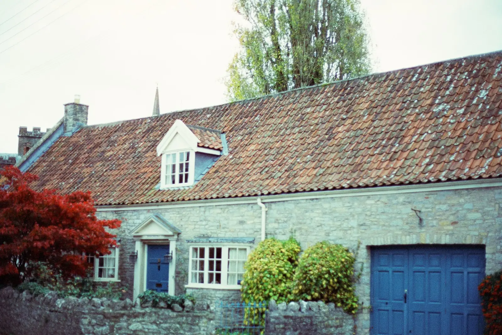 Stone cottage with an attached garage door ready for conversion